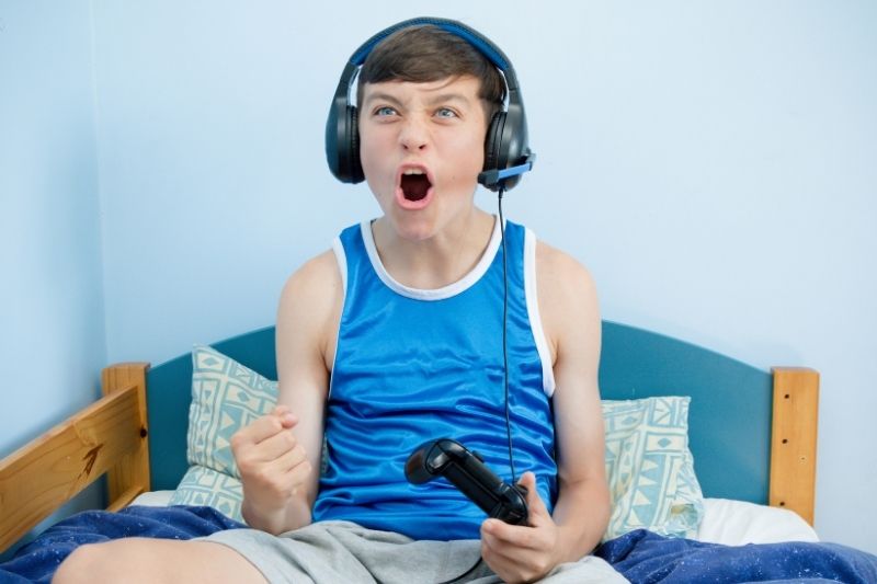 teenage boy playing a video game