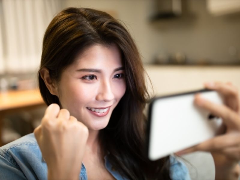 woman playing game on smartphone