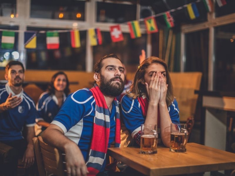 couple watching a game at a bar